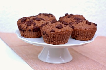 Chickpeas on the wooden spoon on the brown background, front view