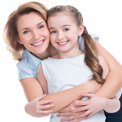 Closeup portrait of happy mother and young daughter