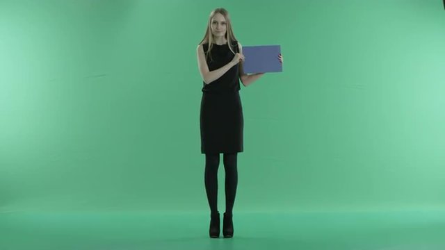 girl holding a blue screen on a green background