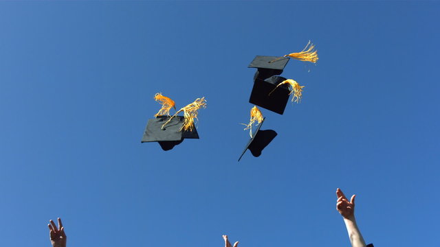 Graduates thow caps, slow motion