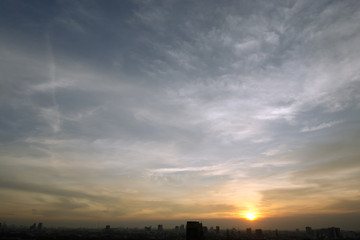 Evening sunset with cloudy skies and silhouette building scene