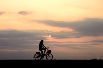 Fototapeta premium Silhouette of cyclist motion on sunset background