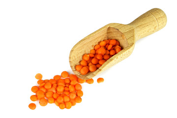 Red lentils in wooden scoop