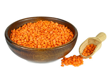 Red lentils in bowl isolated on white background