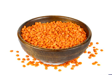 Lentils in wooden bowl isolated on white background