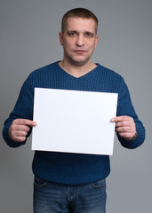 man holding a white sheet of paper