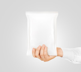 Blank white snack bag mock up hold in hand isolated. 