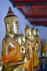 golden buddha statues in a row