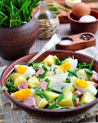 Salad of wild garlic with boiled potatoes, eggs, ham, parmesan and arugula