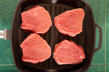 Above view of raw fresh marbled meat steaks, studio shot, closeup