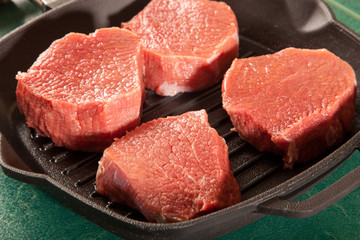 Above view of raw fresh marbled meat steaks, studio shot, closeup