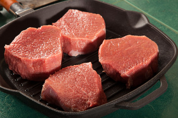Above view of raw fresh marbled meat steaks, studio shot, closeup