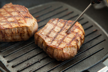 grilled beef steak with rosemary on frying pan
