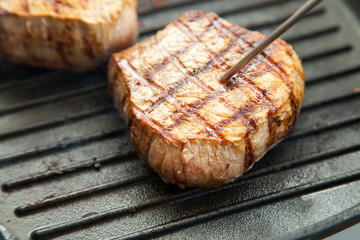 grilled beef steak with rosemary on frying pan