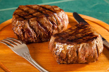 Beef steak cooked to medium rare on wooden background