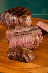 Beef steak cooked to medium rare on wooden background
