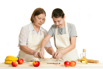 the grandmother and the granddaughter stack dough