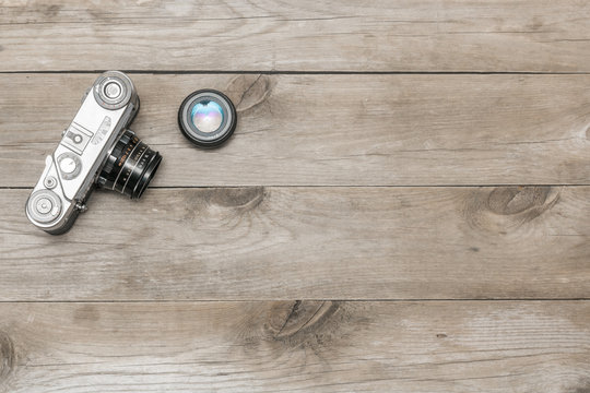 retro camera lying on the aged boards