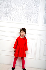 Fototapeta na wymiar little girl in red dress in studio