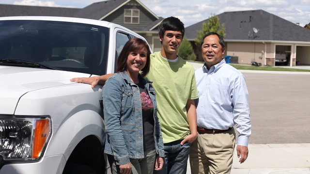 Portrait of teen driver and parents