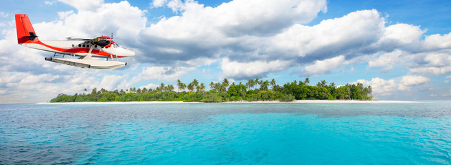 Sea plane flying above Maldives islands