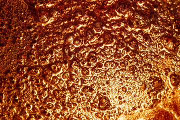 molten glass golden color, background texture.