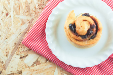cinnamon roll on wooden background
