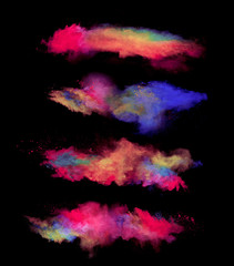 Explosions of colored powder on black background