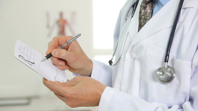 Doctor writing a prescription, close up
