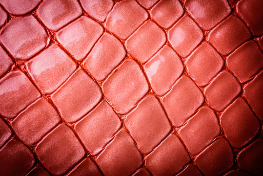 Natural pink leather background closeup.