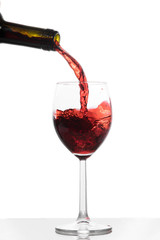 Red wine pouring from a bottle into a glass