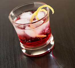 Cranberries cocktail with ice and lemon garnished