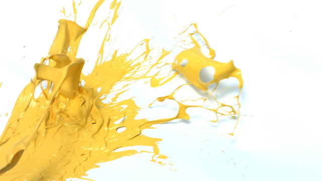 Yellow paint splattering on white background
