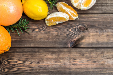 Citrus fruits on wooden table, selective focus.