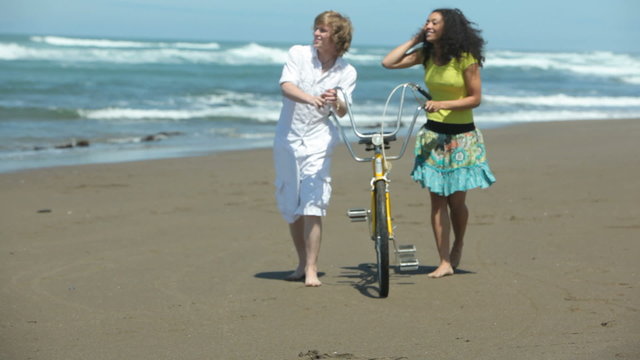 Couple at beach with tandem bicycle
