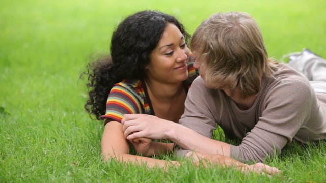 Couple laying in grass together