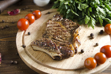 grilled steak on wooden board on wooden background