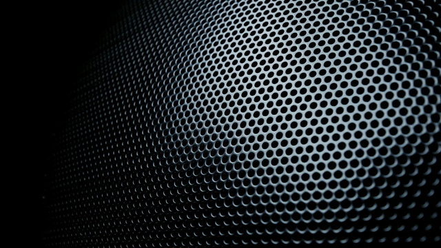 Dark metal background with perforated holes. 