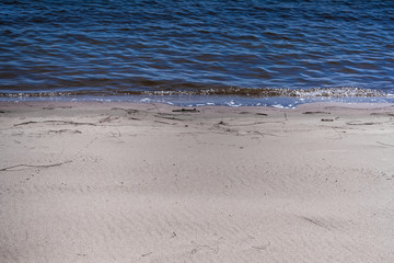 the sandy beach at the blue river with traces