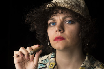 Cigar Lady/Attractive, stylish Caucasian woman with cigar & smoke in her mouth looking at camera
