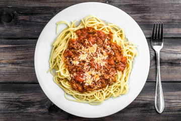 Cooked spaghetti bolognese on white plate..