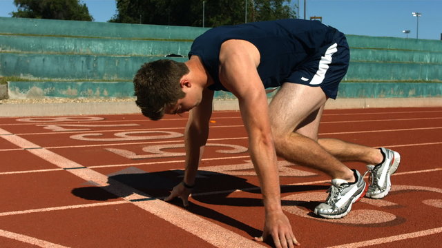 Track runner at starting line, slow motion