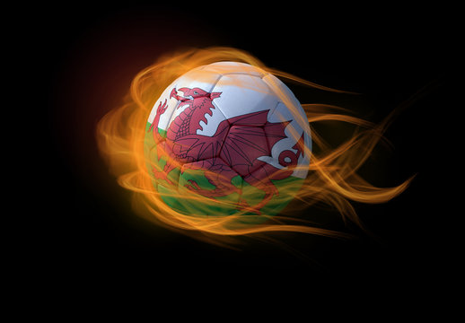 Soccer ball with the national flag of Wales, making a flame.