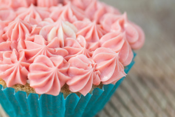 Cupcake with pink icing close up
