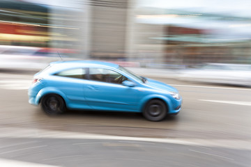 Obraz na płótnie Canvas Car in motion blur, car driving fast in city