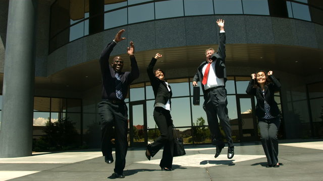 Businesspeople jumping and cheering, slow motion