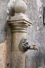 Old vintage water tap on the wall in Mergozzo Italy 