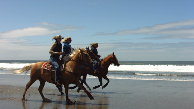 Horseback riding on beach, slow motion