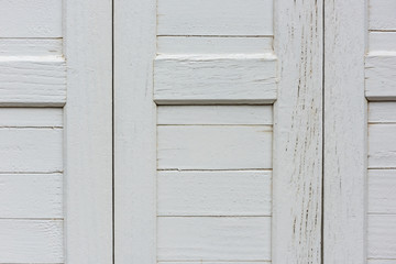 window with closed beige wooden shutters