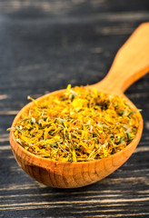 Dry calendula in spoon